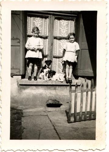 Two children standing window