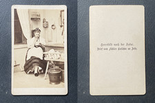 Young peasant woman in regional costume near&#039;a wooden crib, circa 1870 CD