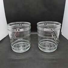 2 glass jars with metal handles