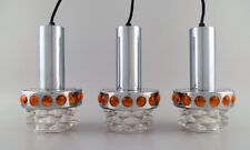 Raak, Holland. Three ceiling pendants in chromed metal and art glass. 1970s.