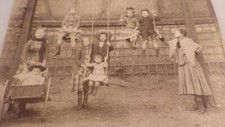 1885. children swinging (photograph).
