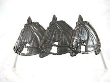 BRONZED HAIR CLIP FROM THE CADRE NOIR DE SAUMUR, SIGNED.