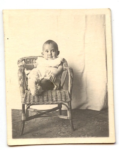 Portrait child sitting wicker