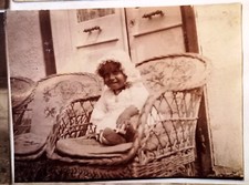 AZ472 photo circa 1914 July children on a rattan armchair