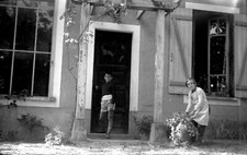 Child in front of house boy little girl garden - old photo negative year. 1950