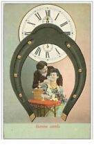 HAPPY YEAR.CLOCK.COUPLE IN A HORSESHOE IN FRONT OF A CLOCK.CP WAFFLE