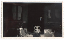 Enfant assis devant porte