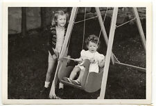 Children swing games garden - old photo snapshot year. 1949