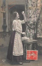 CP WOMAN CLOGS APRON BASKET EGGS ON TABLE OBSERVING EGG