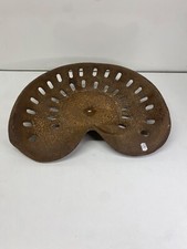 Antique iron tractor seat to