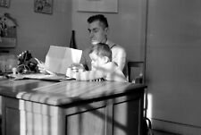 Man at his desk with child - Old photo negative year. 1950