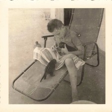 OLD 1960 PHOTOGRAPH A CHILD FEEDING BOTTLE TWO SMALL CIVETS