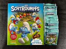 LOT PANINI 50 POCHETTES PACKETS + ALBUM VIDE LES SCHTROUMPFS MONDE MAGIQUE 2023