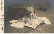 Child - Girl under a cello and on sheet music