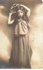 Child - Girl putting a wreath of flowers in her hair