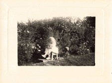 OLD PHOTOGRAPH GIRL IN THE GARDEN ON HER LITTLE CHAIR