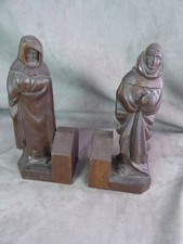 Carved wooden bookends, decorated with monks.