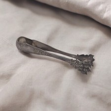 A Silver Metal Sugar Tongs Punch 