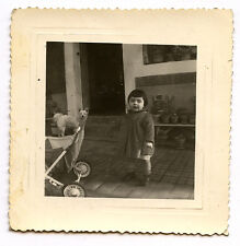 Little girl + stroller + white dog - old photo year. 1950