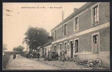 Old postcard Montolivet, Main Street with lively street scene and bicycles in front of a building 