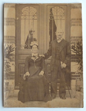 Couple posing in front door entrance - old photo snapshot