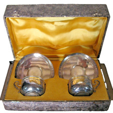 pair of silver metal cups