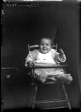 Portrait child baby in high chair - old photo negative glass year. 1920