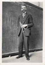 OLD PHOTOGRAPH TEACHER IN FRONT OF HIS LARGE BLACKBOARD