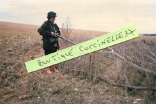 Photo of a hunter with her shotgun woman hunter on the plain