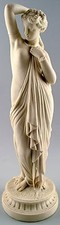Antique large biscuit figure of semi-nude woman in classical style.
