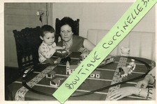 Photo of young boy playing with his toy train circuit
