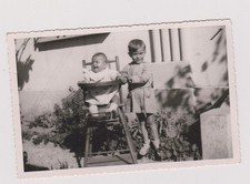 old photo ?️ baby in high chair and big brother protector in the garden