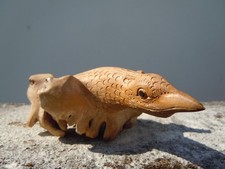 Wooden sculpture bird carved in a root 