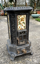 Poêle en fonte et faïence FAURE REVIN en bon état correct . 79 cm