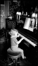 Portrait little girl at piano - old negative photo year. 1920 30