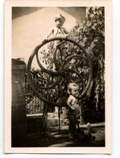 Two little children metal wheel - old photo year. 1940