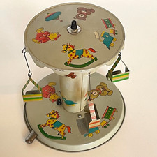 1970's METAL STEERING WHEEL CAROUSEL 4 WHEEL CHAIRS MECHANICAL TOY