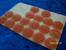 Lot of 18 Antique Orange Galalite Buttons. Spiral flower. Ref No. 687