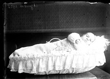 Portrait child baby crib - old glass photo negative year. 1920