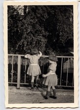 Portrait of 2 children playing railing - old photo year. 1950