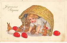 Happy Easter - Baby hiding with rabbits under basket surrounded by