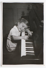 Girl leaning piano keyboard happy music - old photo snapshot
