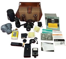 CANON A1 CAMERA N. 235389. WITH BRIEFCASE, LENSES, FLASHES AND PAPERS. JAPAN. XX