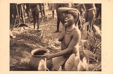 Central African Republic - Boubou woman in front of her husband's funeral urn -