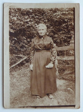 Woman in front of old country fence - old photo snapshot sepia