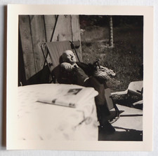 Man sleeping on a deckchair in the sun - vintage photo snapshot c. 1960