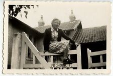 Woman sitting on barrier Pitchounette portal - old year photo. 1930 40