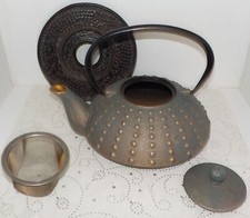 Théière en fonte d'Asie couleur cuivré avec support noir