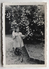 Girl garden flowers scooter, dress, France - vintage photo snapshot 1954