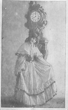 CP YOUNG WOMAN FESANT REVERENCE IN FRONT OF COMTOISE PENDULUM